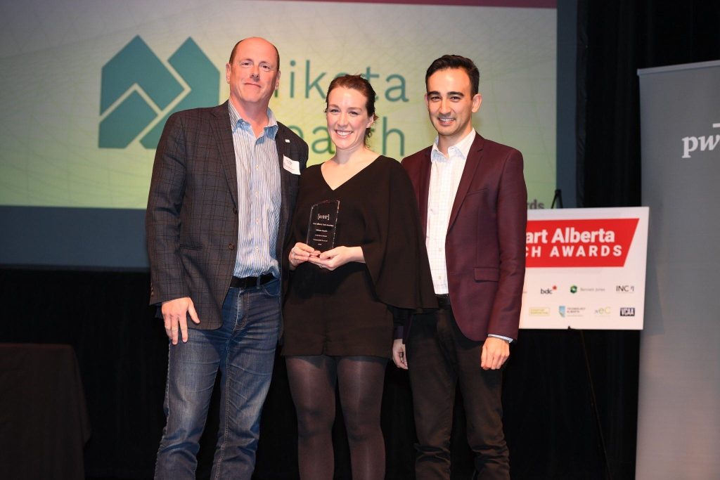 A photo of Calgary-based Mikata Health receiving the 2019 A100 One to Watch Award at the Start Alberta Tech Awards. Shown here accepting the award are Kyle Nishiyama, Mikata Health’s CEO and co-founder (on right), and Meaghan Nolan, MIkata’s chief operating officer and co-founder.