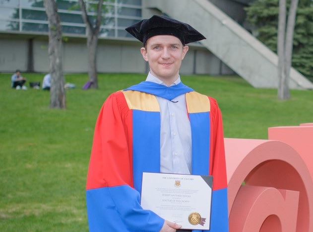 Robert Mayall from FredSense standing outside the University of Calgary after graduating