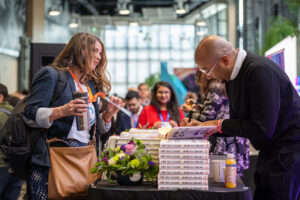 A picture of Marcus Collins signing books at Inventures 2024