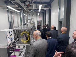 Neil in the background describes part of the facility's processing line