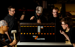 A picture of the TCG Machines team. From left to right:  Daniel Osafo-Mensah, Ramin Asadpour, Joseph Shaheen, Antoine Fecteau, and Emily Wiebe.